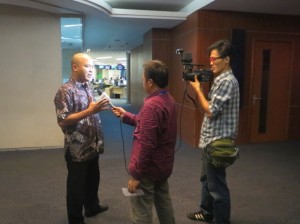 Mr. Maskar is interviewed by a TV journalist about the tempe improvement program in Indonesia.