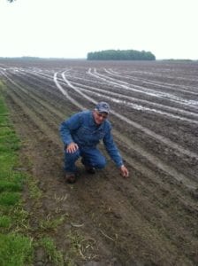 Dwain Ford, on his farm in Kinmundy, Illinois, checking corn emergence in the field.