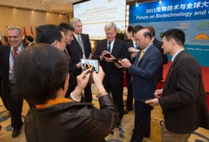 U.S. Ambassador Max Baucus (center) talks with audience members during a break. 