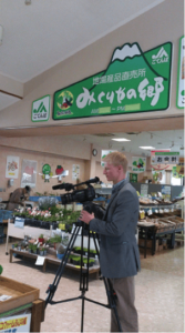 Market Journal producer Kurtis Harms films a farmers market near Mt. Fuji in Japan