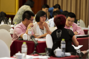 Participants formed groups and discussed their market strategy in the simulation session