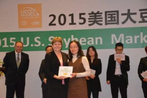 Former USB chairman Vanessa Kummer presents a award to one of the top ten buyers of U.S. soybeans while ASA director Monte Peterson observes at the awards ceremony