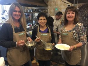 MAGIC III team members Pilu Giraudo, Nancy Kavazanjian and Dawn Scheier prepare recipes for the Guokr town hall meeting