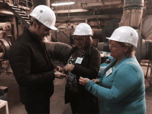 USB director April Hemmes discusses pellet quality with Vincent Demiot, production manager at Terrena and USSEC consultant Lola Herrera during her visit to France