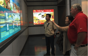 Mr. Sukalski, Mr. Zhang, and Ms. Chong visit the products shown at Yihai Kerry Group in Qinghuangdao