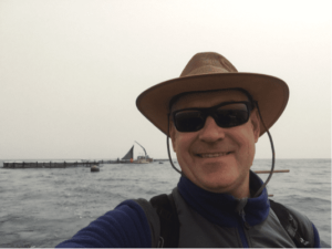 USSEC Aquaculture Program Lead Technical Consultant - SEA Lukas Manomaitis with offshore cages in background near Malta