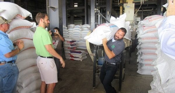 ASA director and Michigan grower Matt Stutzman gets the feel of a 60 kilogram feed bag as he loads it into a truck