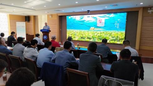 A classrooom filled with agribusiness professionals with a presentation